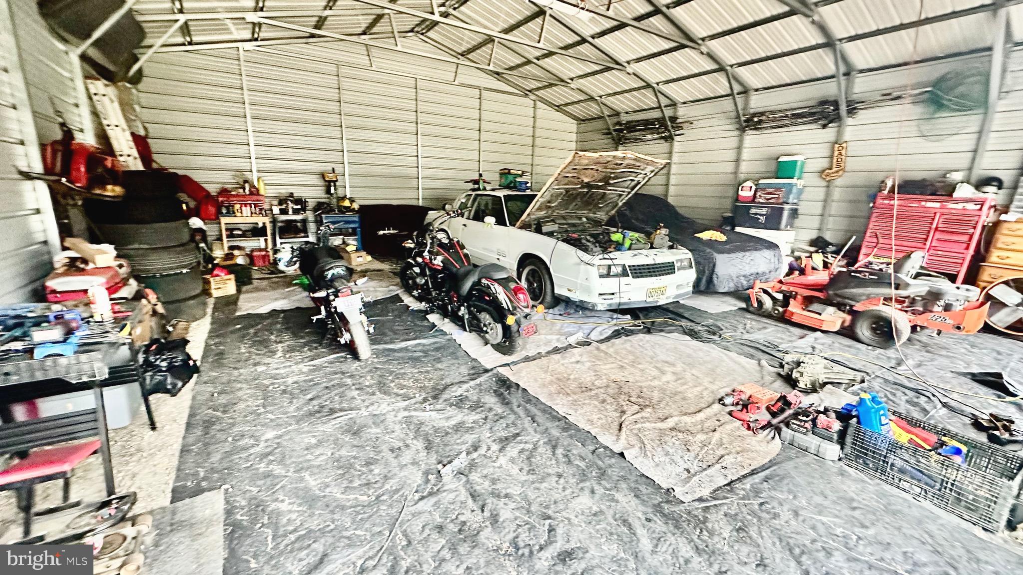 69 High Street Leesburg, NJ 08327 - Photo 32 of 34 a storage room with lots of clutter and chairs