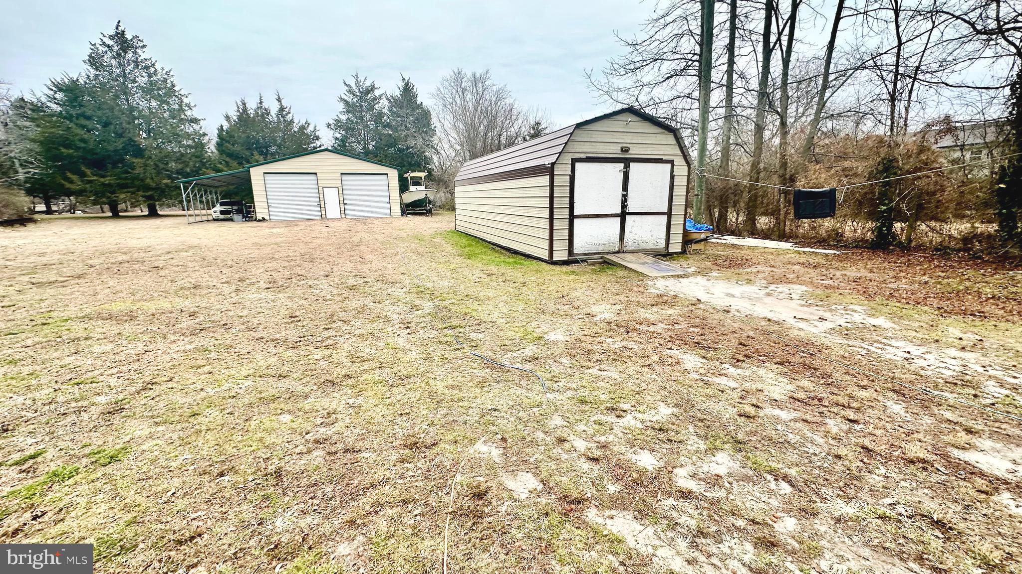 69 High Street Leesburg, NJ 08327 - Photo 33 of 34 a view of a house with a yard covered in snow