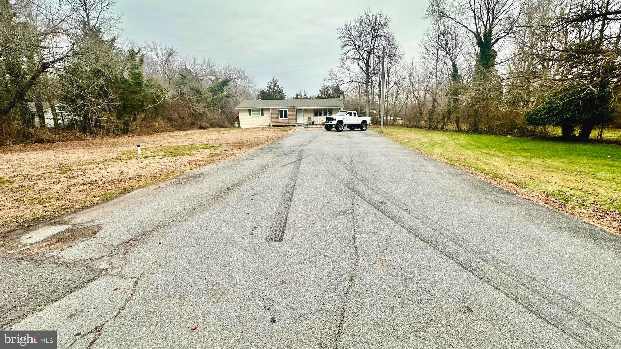 69 High Street Leesburg, NJ 08327 - Photo 4 of 34 a view of a swimming pool with a yard and trees