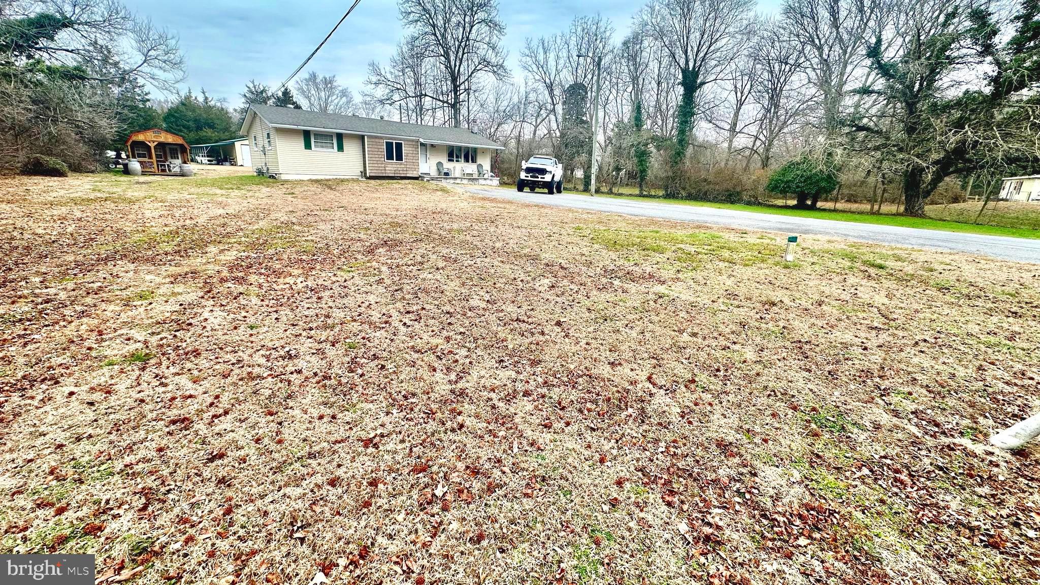 69 High Street Leesburg, NJ 08327 - Photo 5 of 34 a front view of a house with a yard and garage