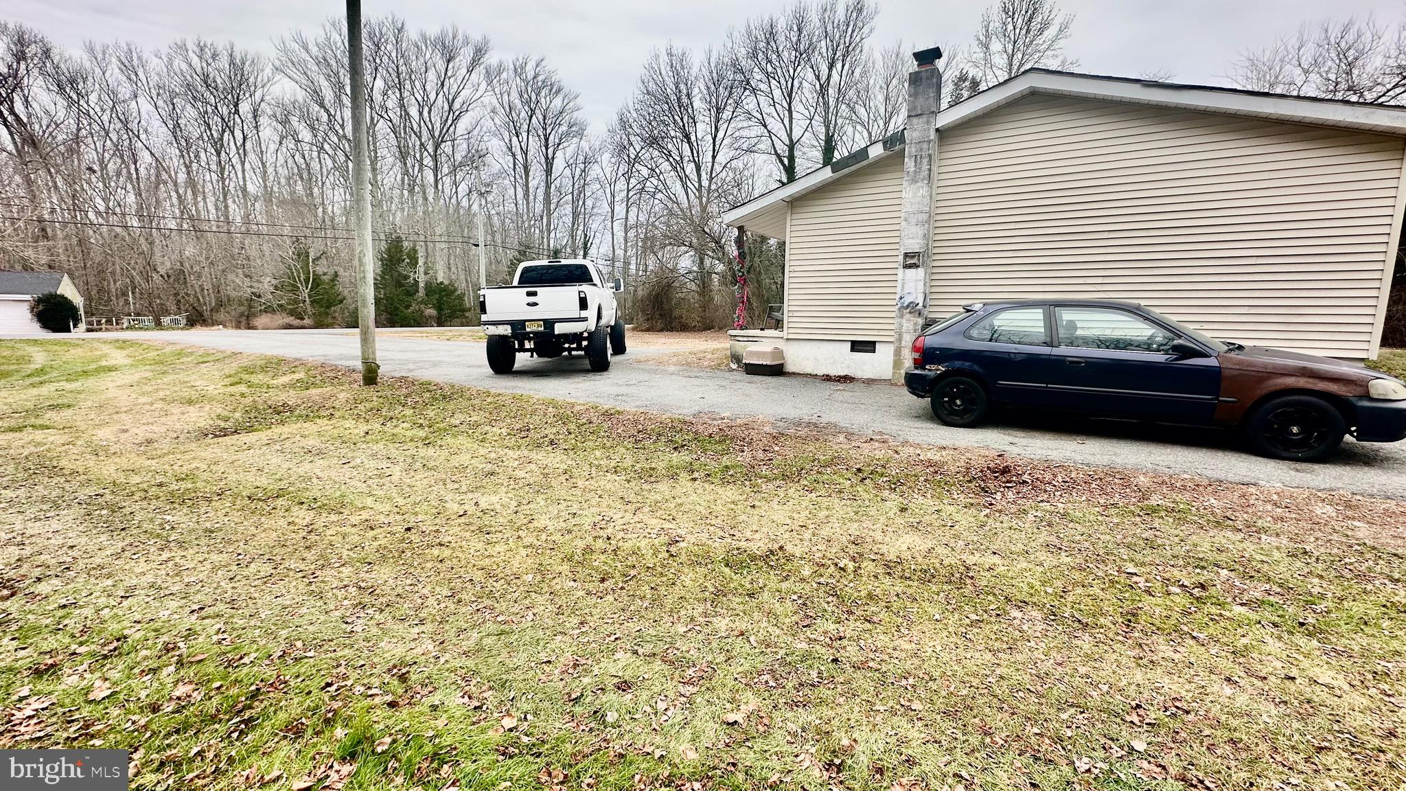 69 High Street Leesburg, NJ 08327 - Photo 7 of 34 a car parked in front of a white house