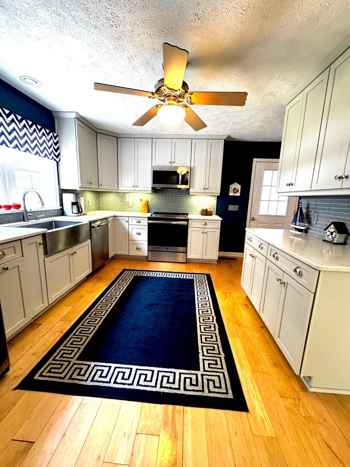 521 Painter Point Road Kilmarnock, VA 22482 - Photo 25 of 52 a kitchen with stainless steel appliances granite countertop a stove a sink and a microwave