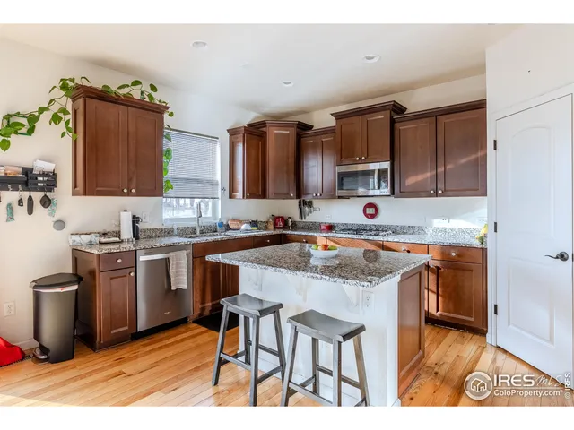 a kitchen with stainless steel appliances granite countertop a stove top oven a sink a counter space and cabinets