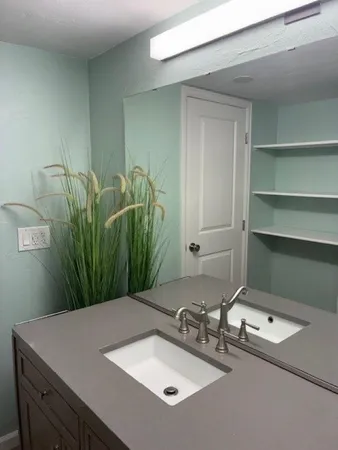 a bathroom with a sink vanity and a mirror