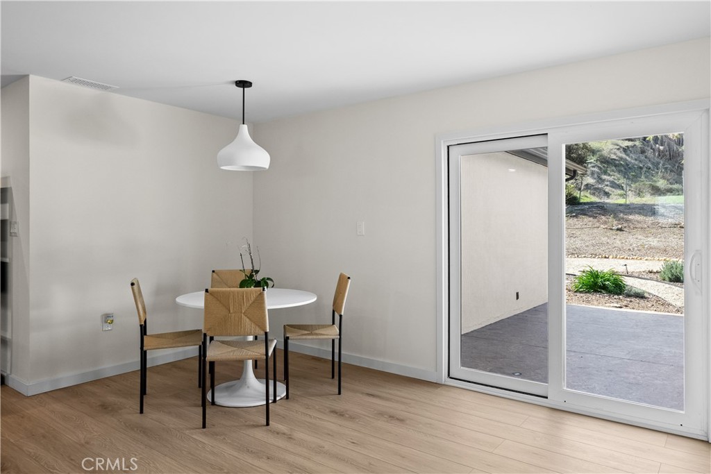 6 Santa Clara Drive Lompoc, CA 93436 - Photo 12 of 40 a dining room with wooden floor a chandelier