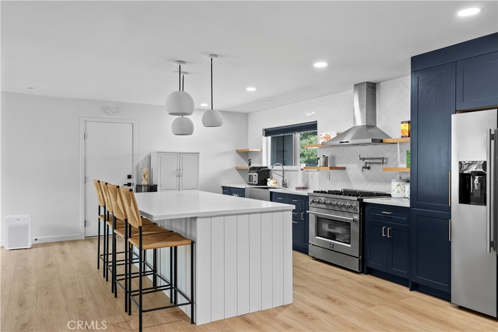 6 Santa Clara Drive Lompoc, CA 93436 - Photo 9 of 40 a kitchen with stainless steel appliances a dining table chairs stove refrigerator and cabinets