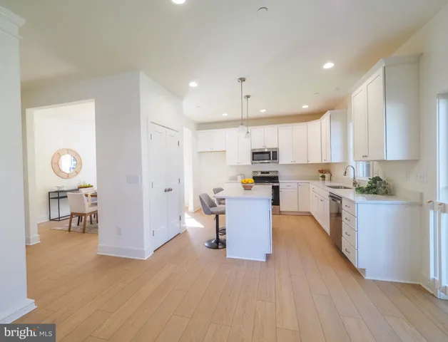 a kitchen with cabinets and wooden floor