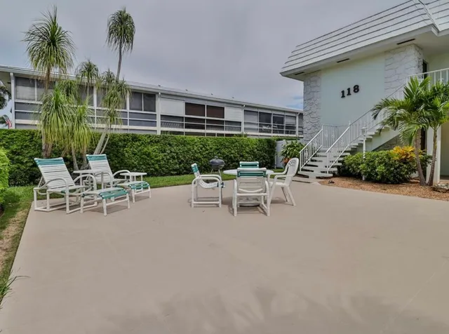 a white bench sitting in front of a house