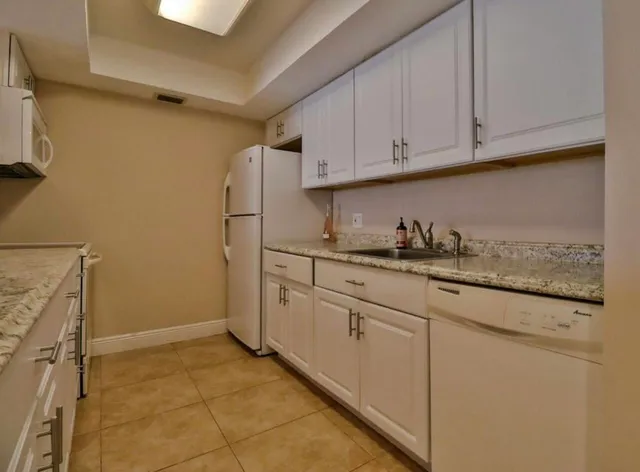 a kitchen with granite countertop cabinets and sink