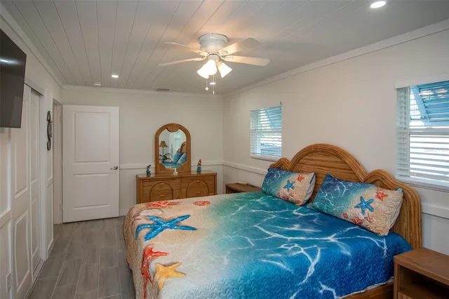 a bedroom with a bed and a chandelier