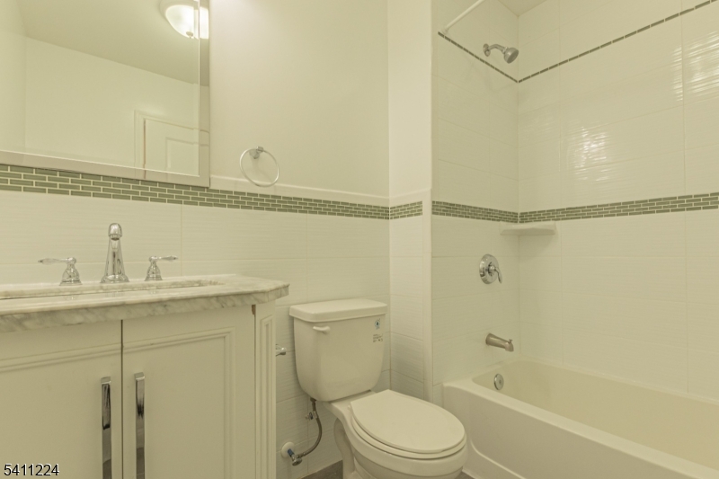 238 James Street Hackensack, NJ 07601 - Photo 16 of 24 a bathroom with a granite countertop sink toilet and shower