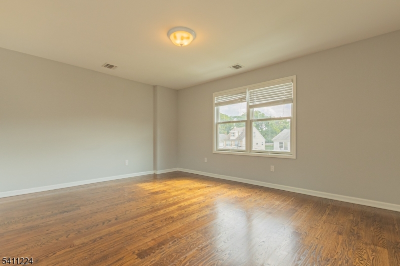 238 James Street Hackensack, NJ 07601 - Photo 17 of 24 an empty room with wooden floor and windows