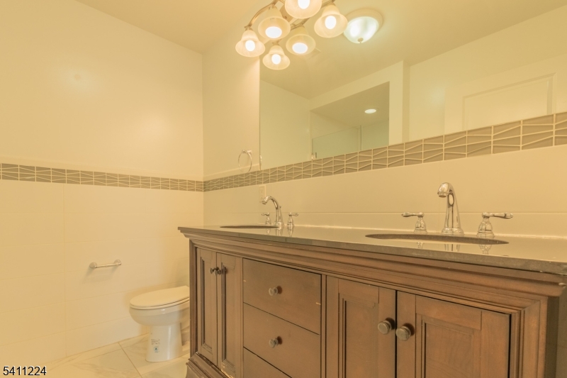 238 James Street Hackensack, NJ 07601 - Photo 18 of 24 a bathroom with a sink a toilet and mirror