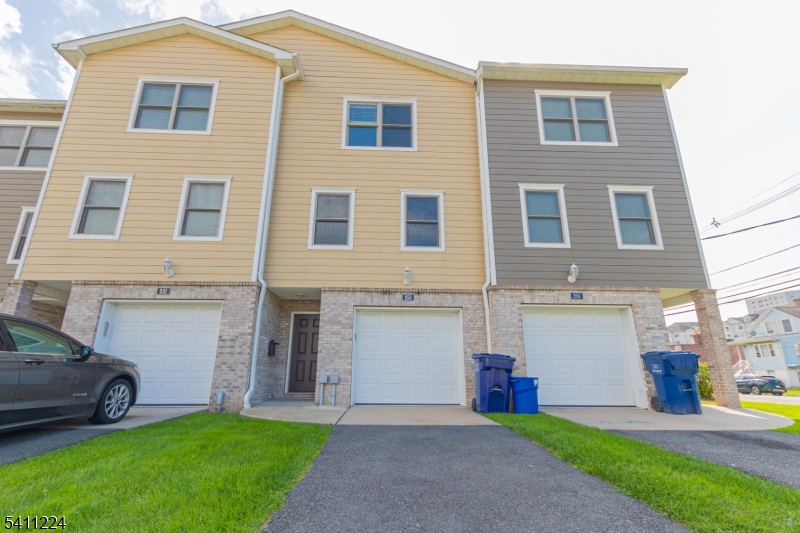 238 James Street Hackensack, NJ 07601 - Photo 23 of 24 a view of a house with a yard and a large parking space