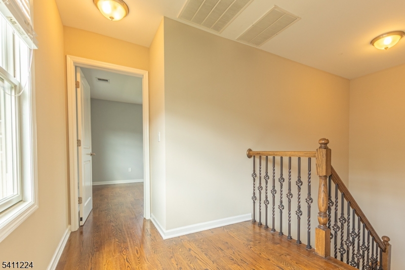 238 James Street Hackensack, NJ 07601 - Photo 6 of 24 a view of a hallway with wooden floor and staircase