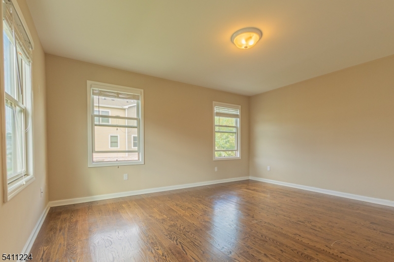 238 James Street Hackensack, NJ 07601 - Photo 9 of 24 a view of an empty room with wooden floor and a window