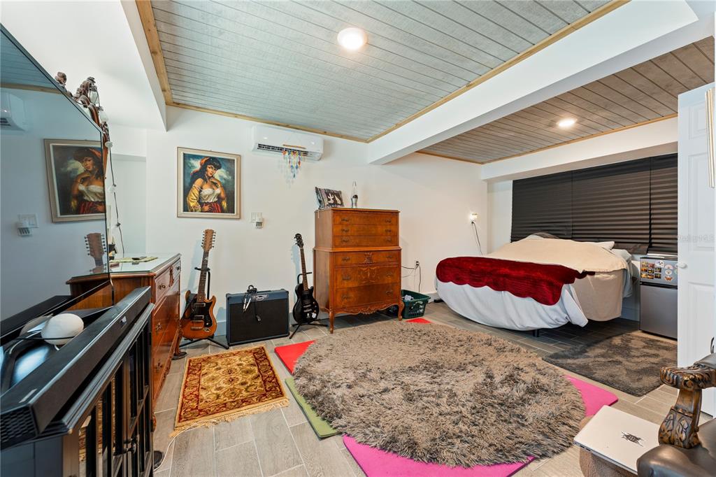 1335 40th Street Sarasota, FL 34234 - Photo 12 of 50 a bedroom with a bed and wooden floor