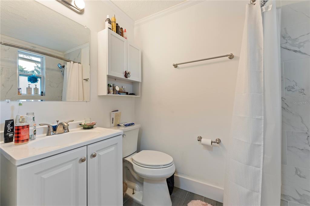 1335 40th Street Sarasota, FL 34234 - Photo 14 of 50 a bathroom with a sink a toilet and a mirror
