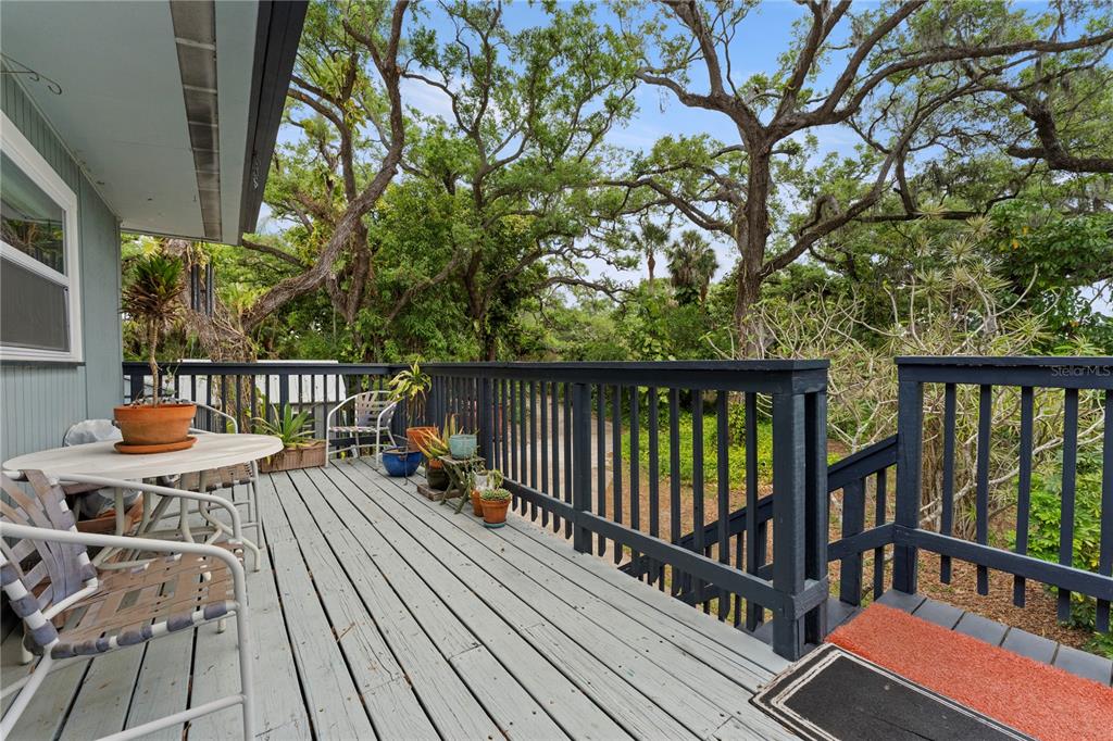 1335 40th Street Sarasota, FL 34234 - Photo 16 of 50 a balcony with wooden floor and outdoor seating