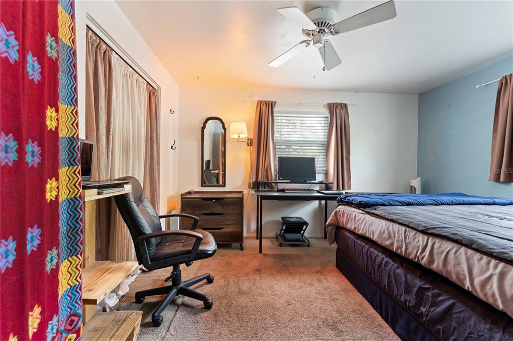 1335 40th Street Sarasota, FL 34234 - Photo 23 of 50 a bed room with a bed and a chair