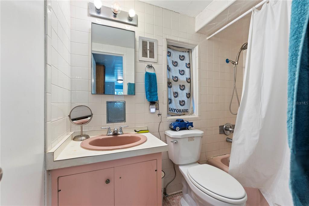 1335 40th Street Sarasota, FL 34234 - Photo 31 of 50 a bathroom with a sink a toilet a mirror a vanity and shower