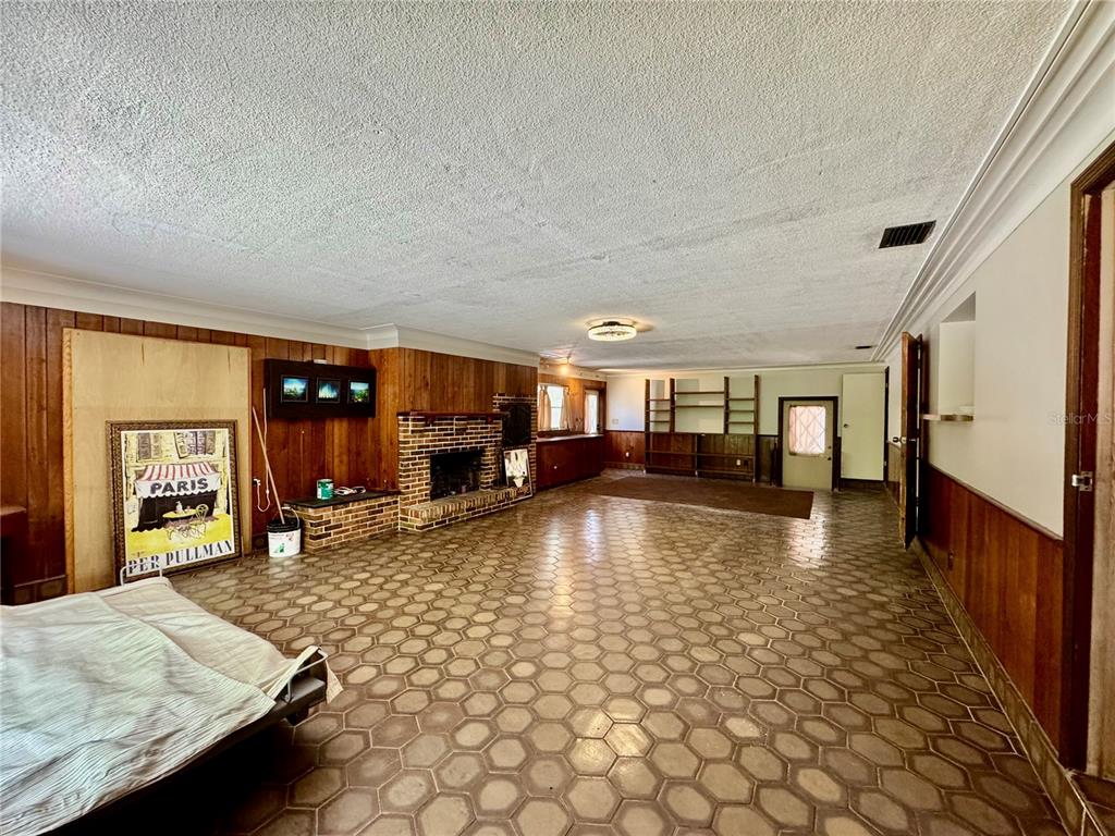 1335 40th Street Sarasota, FL 34234 - Photo 33 of 50 a living room with fireplace furniture and a wooden floor