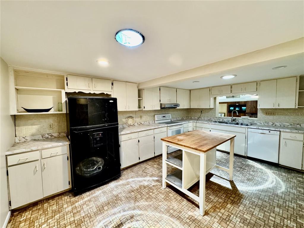 1335 40th Street Sarasota, FL 34234 - Photo 34 of 50 a kitchen with a stove a sink and a refrigerator