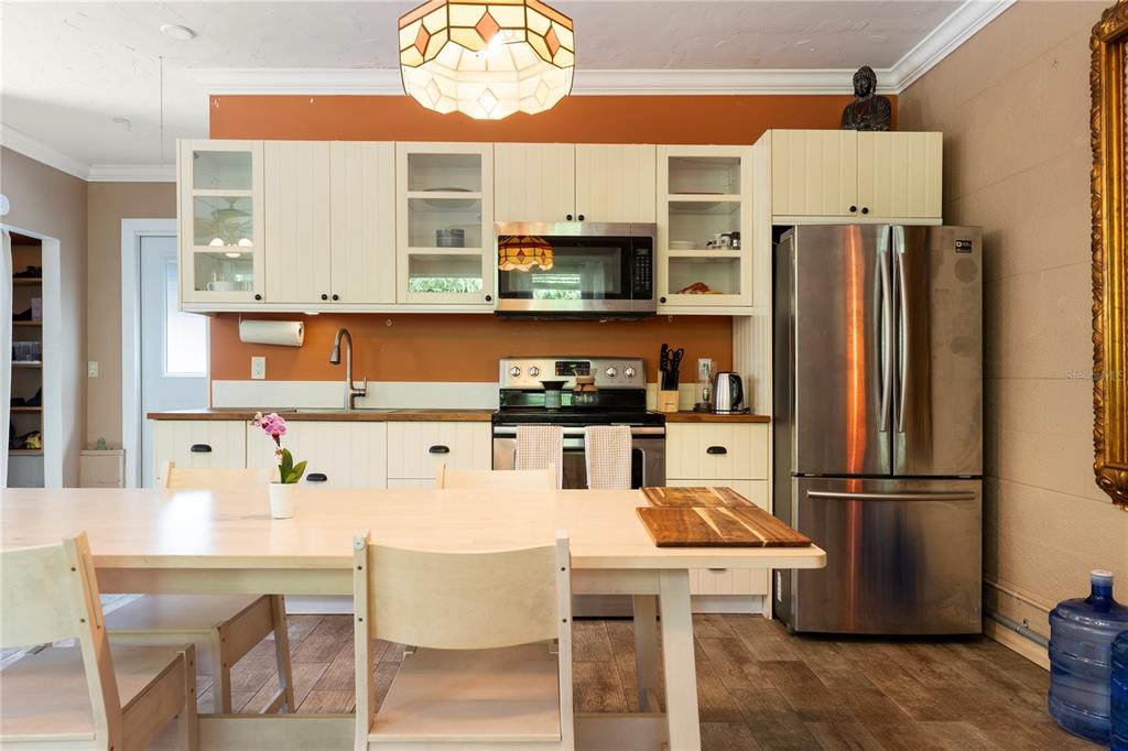 1335 40th Street Sarasota, FL 34234 - Photo 6 of 50 a kitchen with stainless steel appliances granite countertop a refrigerator a microwave a sink and a stove