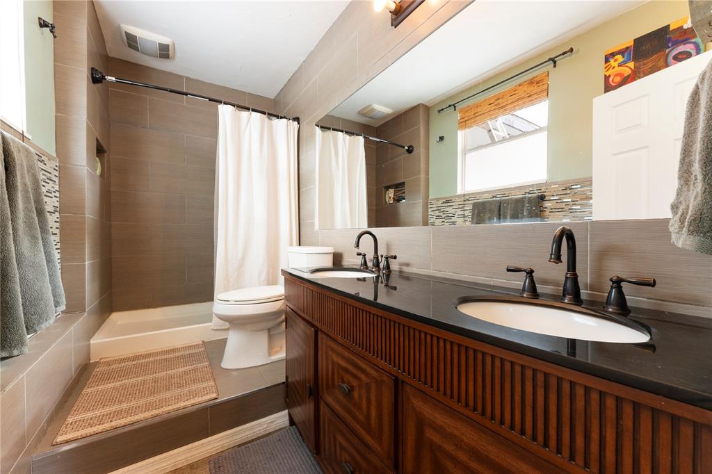 1335 40th Street Sarasota, FL 34234 - Photo 7 of 50 a bathroom with a double vanity sink toilet and a tub