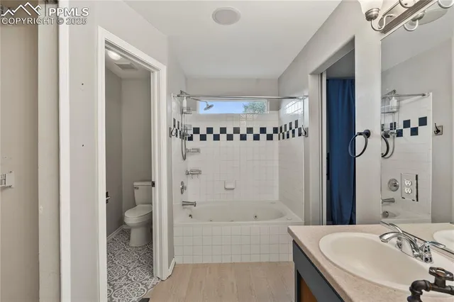 a bathroom with a tub a sink and a mirror