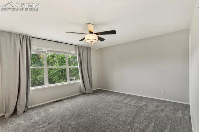 a view of room window and a ceiling fan