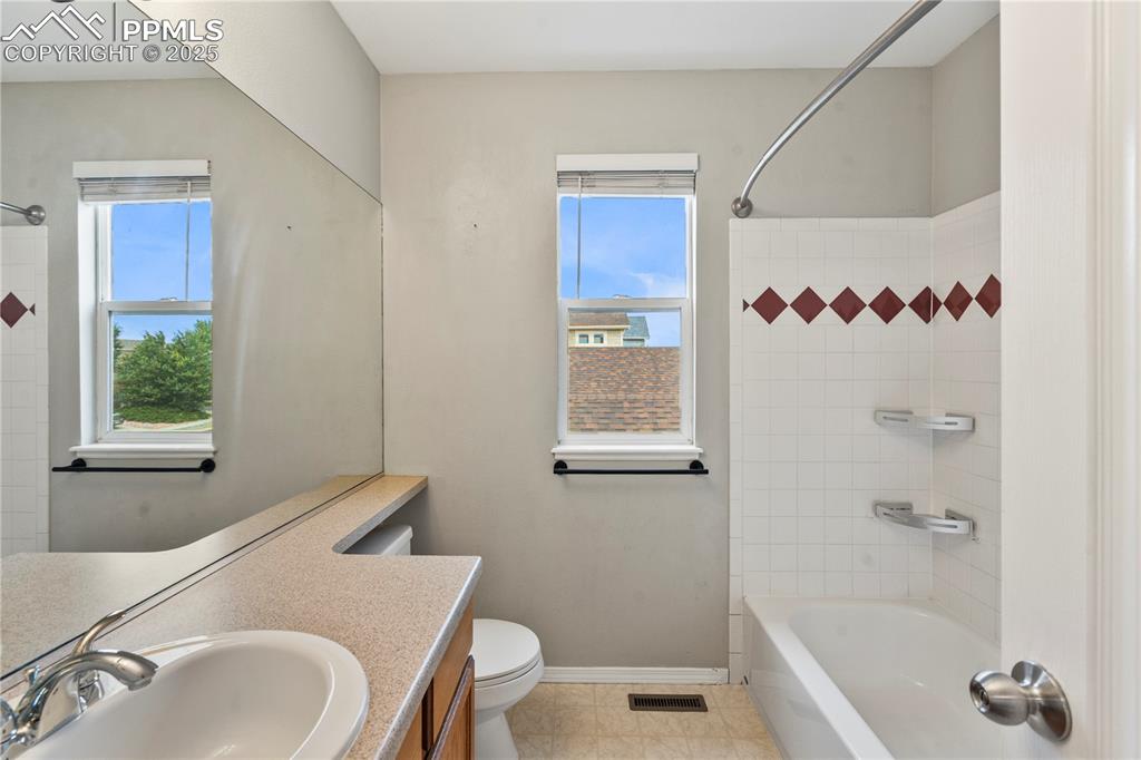3320 Tail Spin Drive Colorado Springs, CO 80916 - Photo 17 of 28 a bathroom with a sink toilet and shower