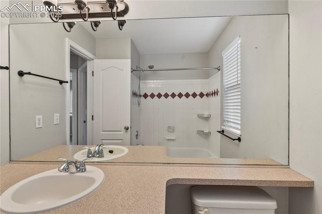 3320 Tail Spin Drive Colorado Springs, CO 80916 - Photo 18 of 28 a bathroom with a sink and a mirror