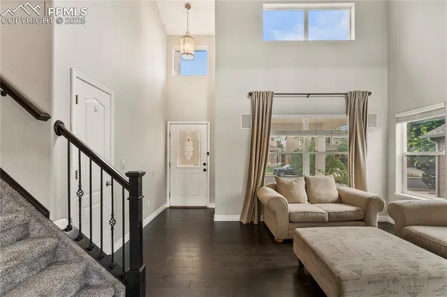 a living room with furniture and a table with wooden floor