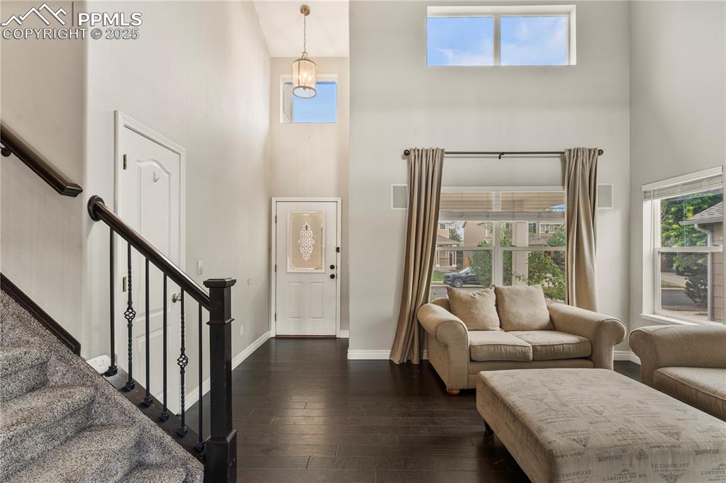 3320 Tail Spin Drive Colorado Springs, CO 80916 - Photo 2 of 28 a living room with furniture and a table with wooden floor