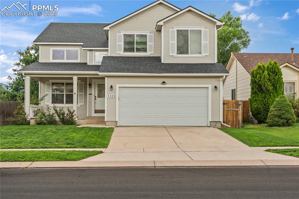 3320 Tail Spin Drive Colorado Springs, CO 80916 - Photo 28 of 28 a front view of a house with a yard and garage