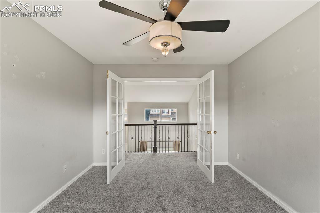 3320 Tail Spin Drive Colorado Springs, CO 80916 - Photo 9 of 28 a view of a hallway with a chandelier