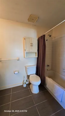 a spacious bathroom with a double vanity sink a toilet and a mirror