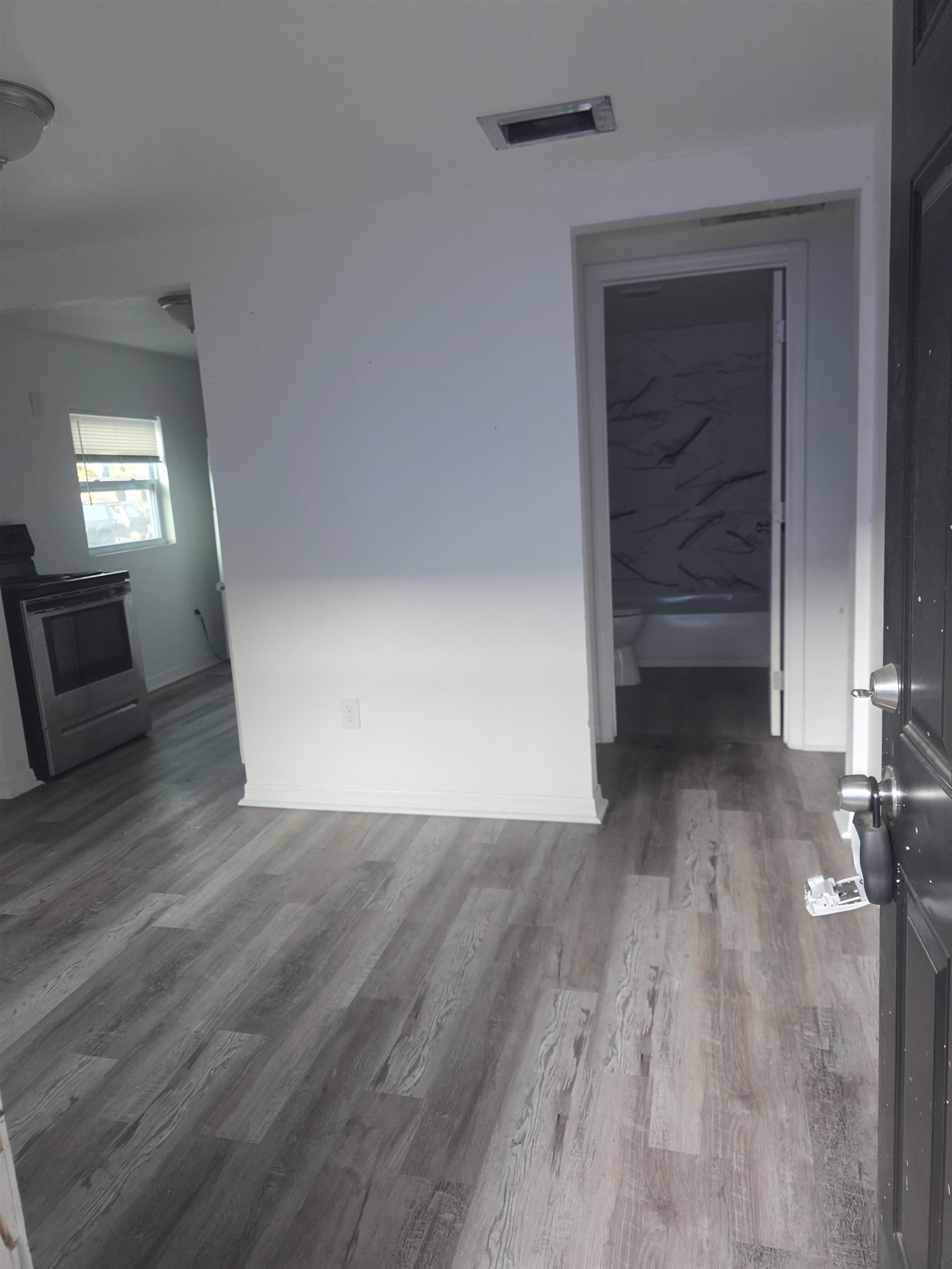 2189 Benedict Road Jacksonville, FL 32209 - Photo 12 of 19 Unfurnished room with wood finished floors