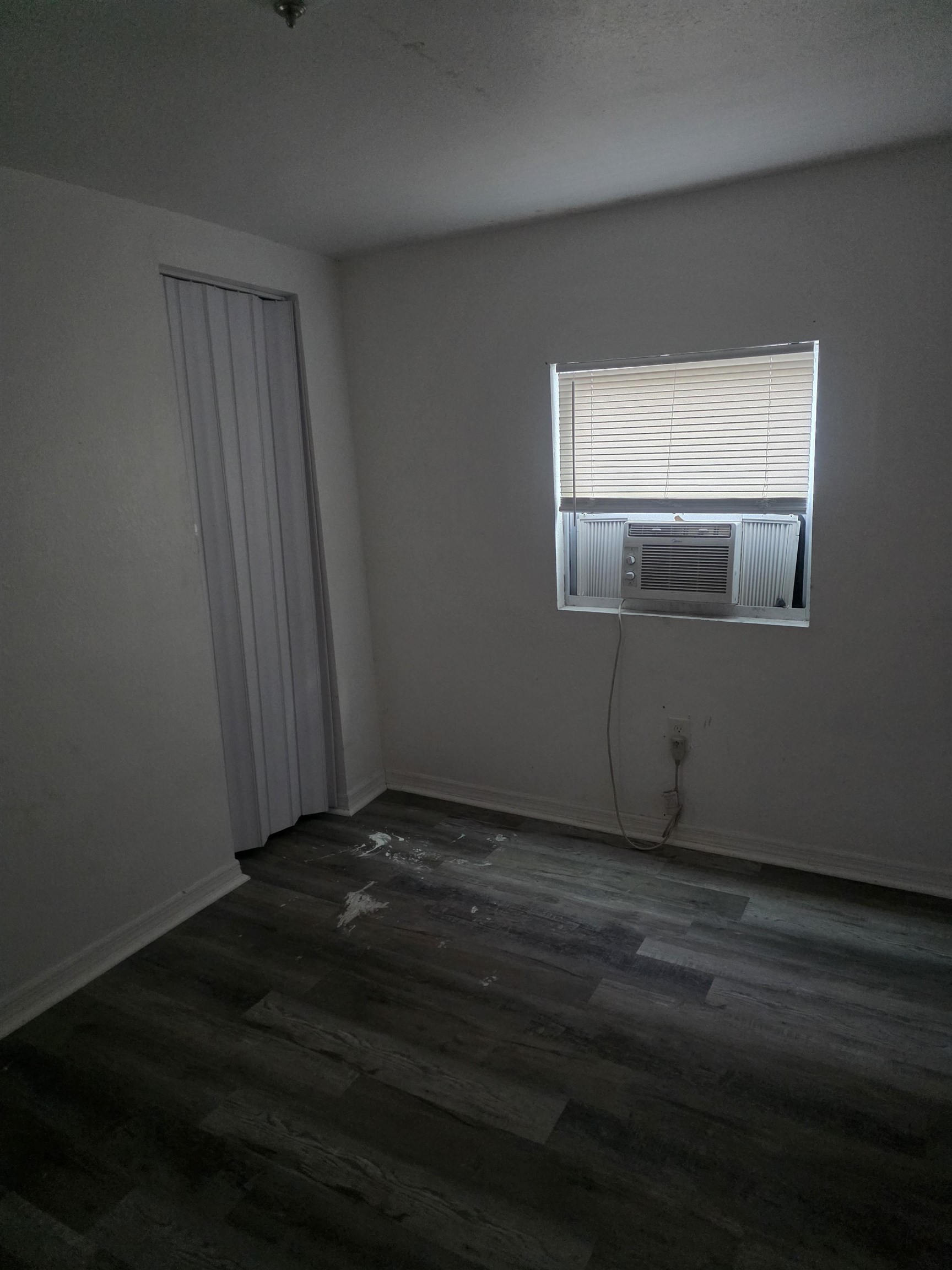 2189 Benedict Road Jacksonville, FL 32209 - Photo 15 of 19 a view of an empty room with wooden floor and a window