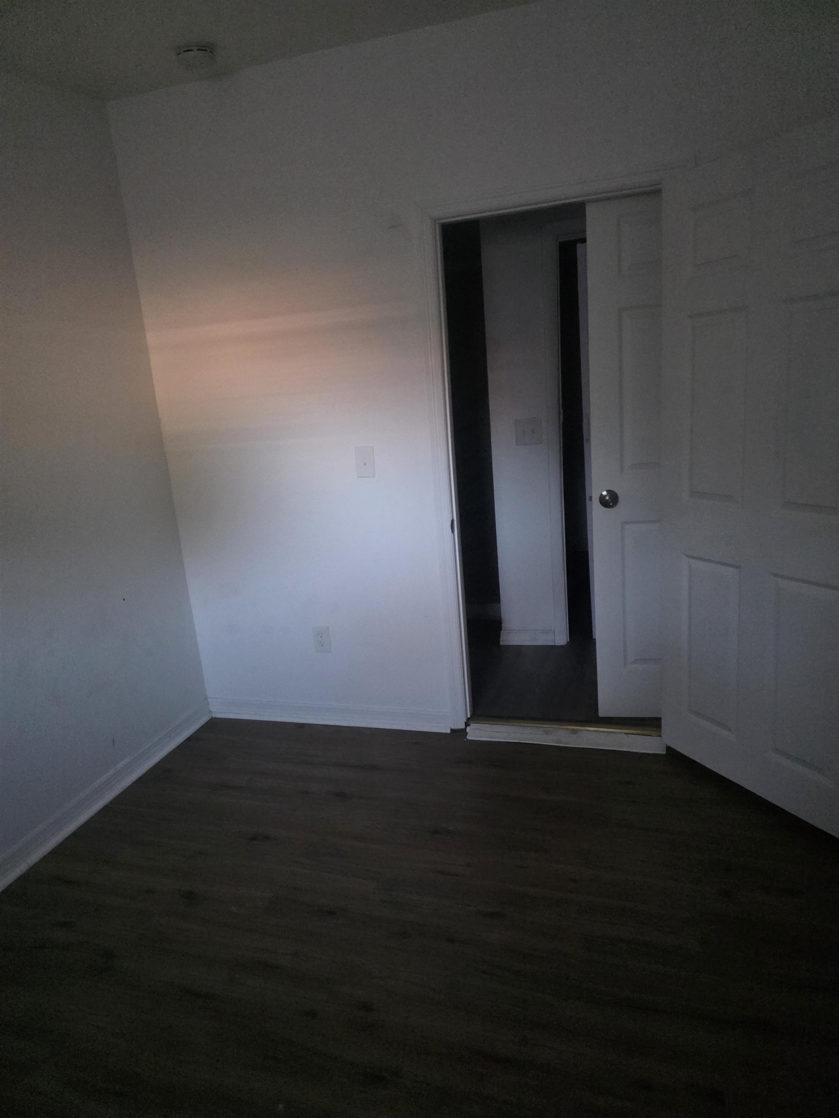 2189 Benedict Road Jacksonville, FL 32209 - Photo 16 of 19 a view of an empty room with wooden floor and a window