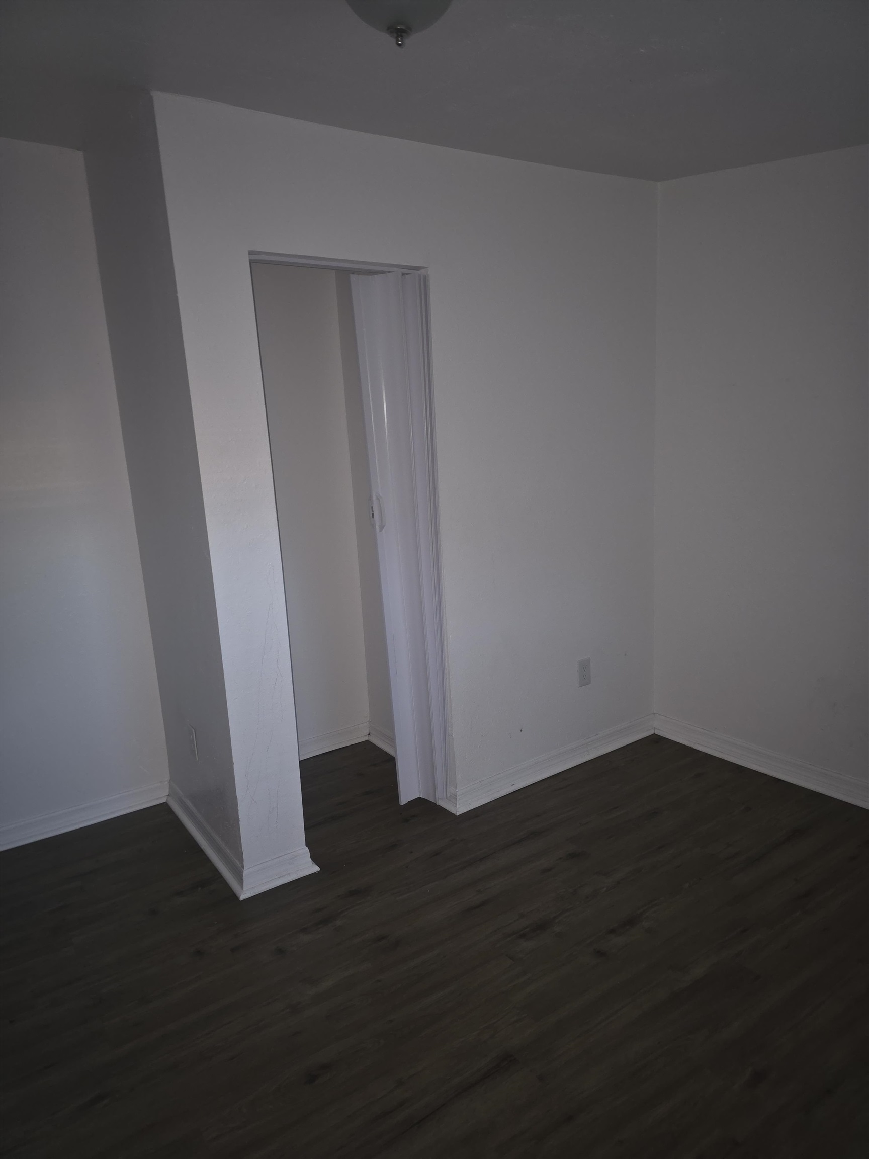 2189 Benedict Road Jacksonville, FL 32209 - Photo 18 of 19 a view of an empty room with wooden floor and a window