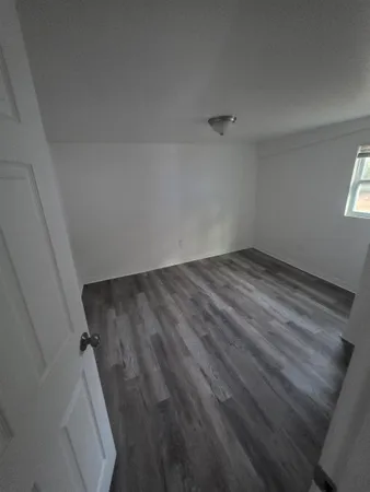 a view of a kitchen with wooden floor and a sink