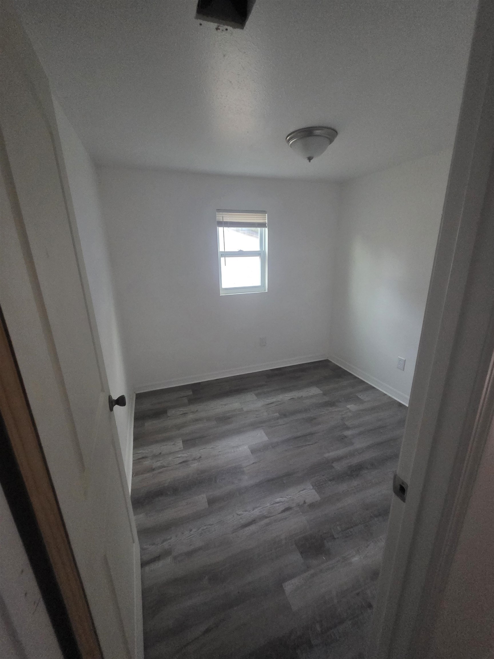 2189 Benedict Road Jacksonville, FL 32209 - Photo 6 of 19 Spare room featuring dark wood-style flooring and a textured ceiling