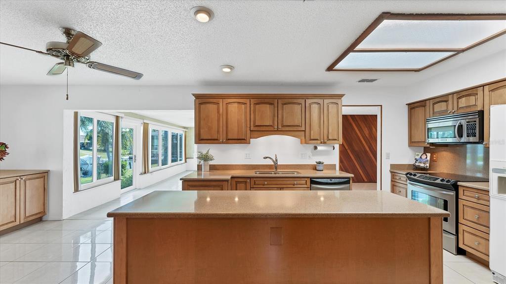 4515 Mangrove Point Road Bradenton, FL 34210 - Photo 14 of 59 a kitchen with stainless steel appliances granite countertop a stove a sink and a refrigerator