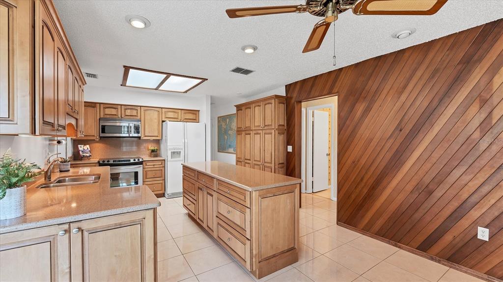 4515 Mangrove Point Road Bradenton, FL 34210 - Photo 15 of 59 a kitchen with stainless steel appliances granite countertop a refrigerator and a stove top oven