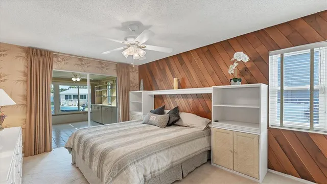 a bedroom with a bed and a large mirror