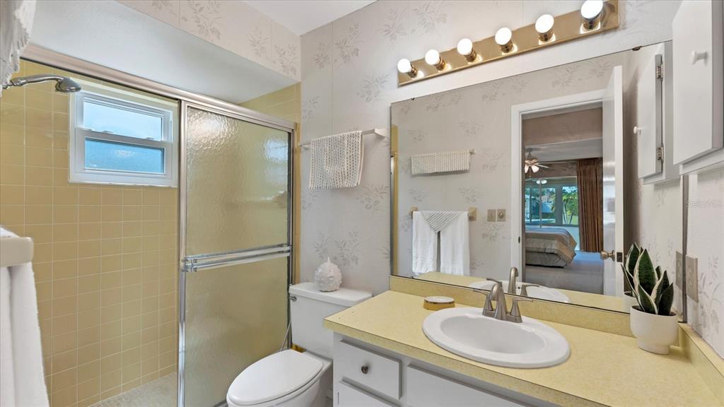 4515 Mangrove Point Road Bradenton, FL 34210 - Photo 24 of 59 a bathroom with a sink toilet and shower