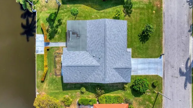 a view of a house with pool and a yard