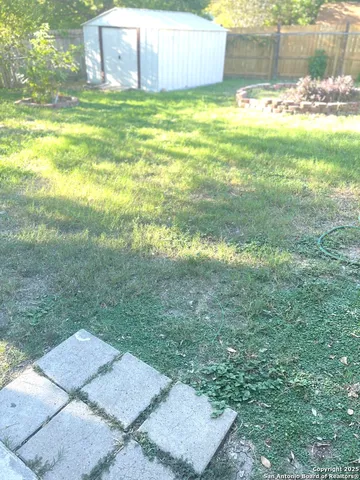 a backyard of a house with table and chairs